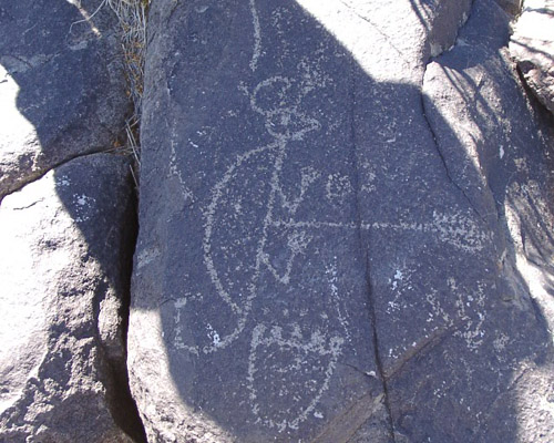 travis shading a petroglyph